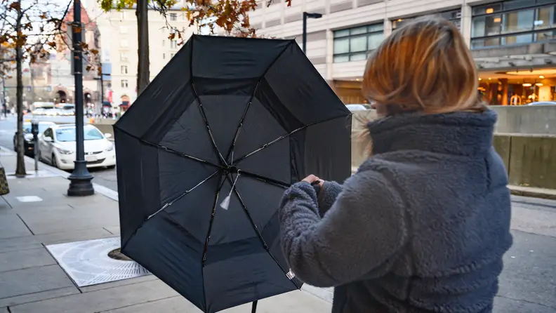 The G4Free Golf Umbrella getting blown inside out by the wind.