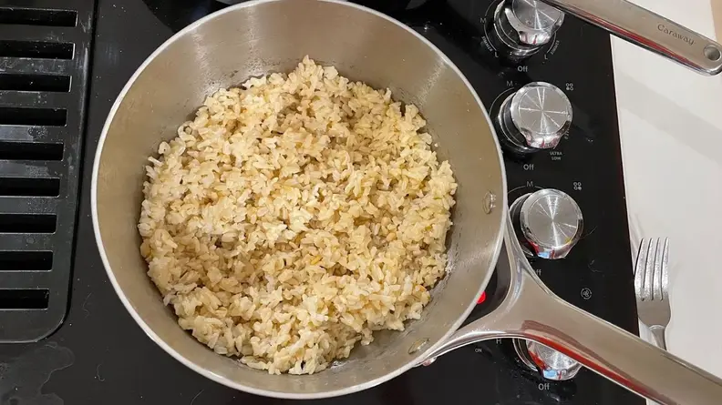 Cooked rice inside of pot.
