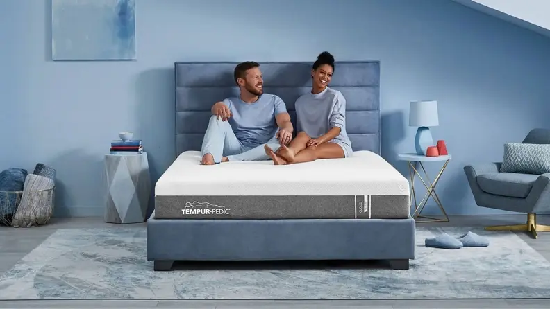 a couple sits on the tempur-pedic mattress