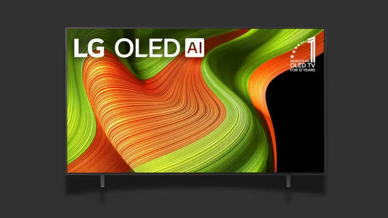 A TV with a colorful screen sits on a black background