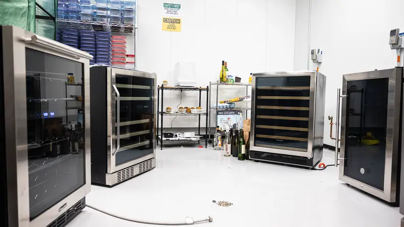 Four different wine fridges are set up in a semi-circle in Reviewed's refrigerator laboratory.