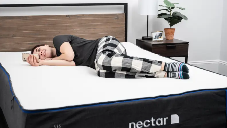 woman lying on side on bed
