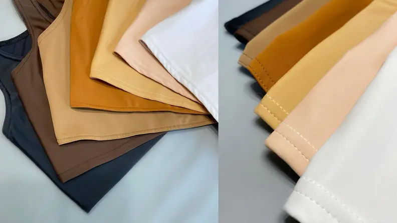 Different colored binders laid out on a white background, demonstrating the different skin-colored selection from white to black.
