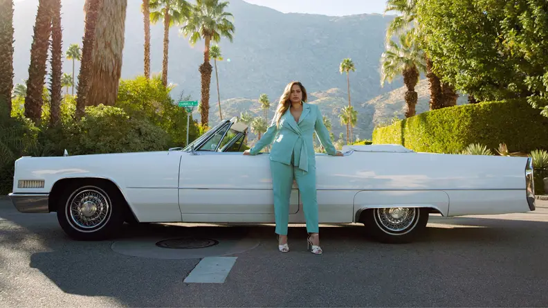 Woman standing in front of a car