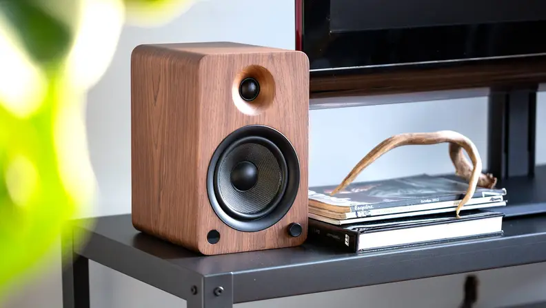 A stand-alone audio speaker next to a turntable