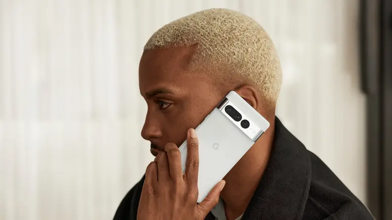 A man talking on a Google Pixel 7 Pro smart phone.