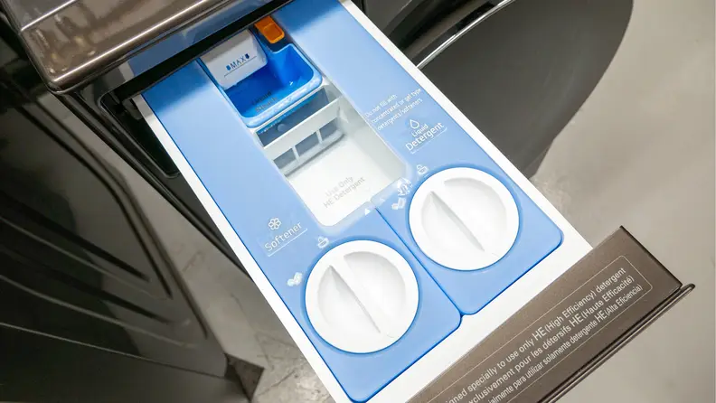 The opened automatic detergent and softener dispenser of the LG WM6700HBA washing machine.