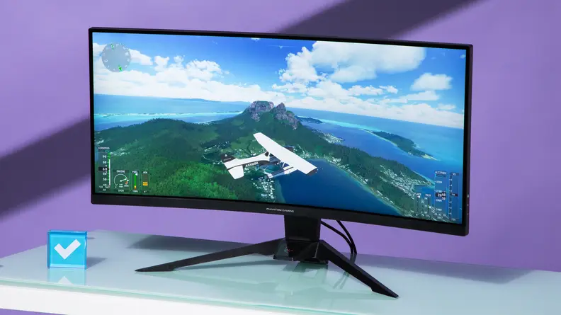 Vibrant colors pop in the image of a plane flying over an island on the screen of an ASRock Phantom Gaming PG34WQ15R2B monitor.
