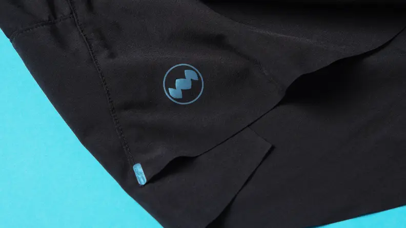 Reflective material on a pair of black Janji running shorts.