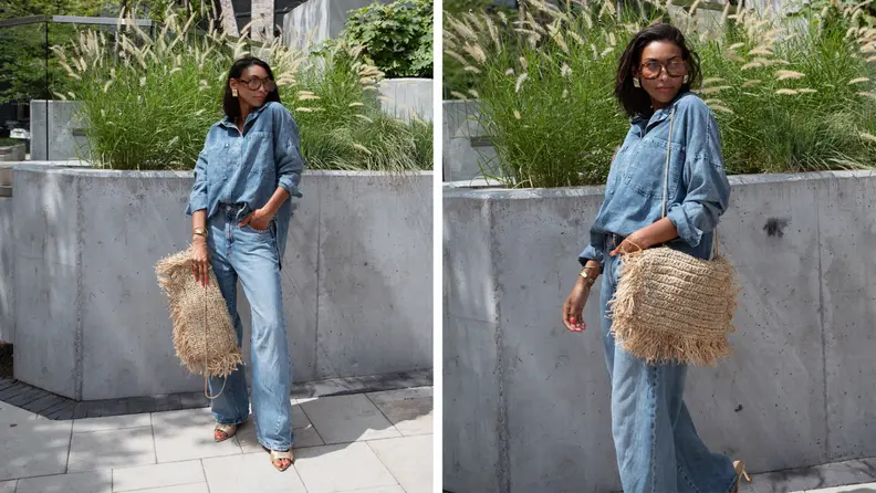 A woman wearing jeans and a denim shirt, gold shoes, sunglasses, and a raffia pillowcase that she turned into a purse.