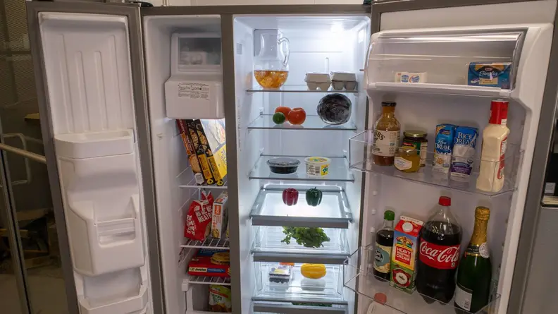 Inside shelving on the Whirlpool WRS331SDHM filled with assorted foods.