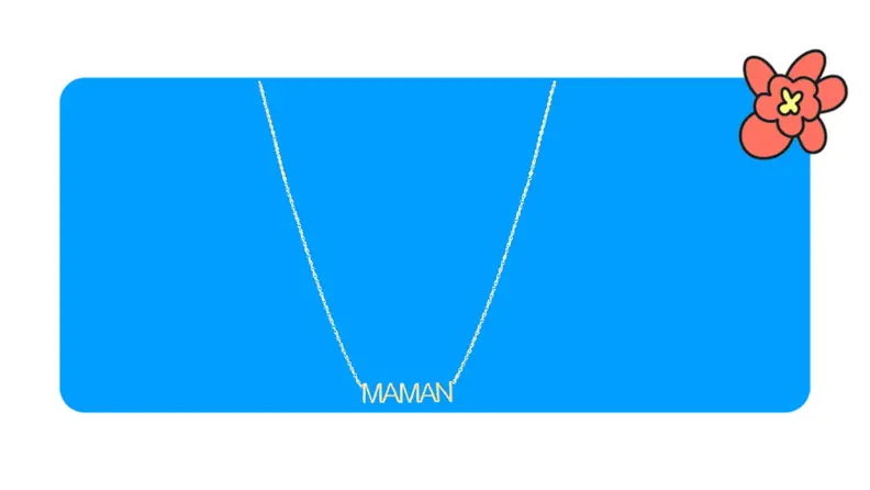 Product shot of a gold Clare V Mamman necklace in front of a blue background with a red cartoon flower in the corner..