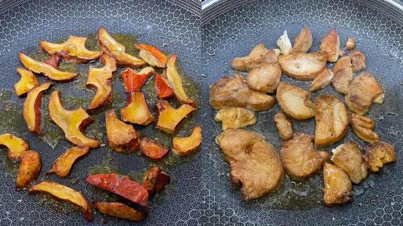 Lobster mushrooms and regular mushroom searing inside of greased skillet pan.