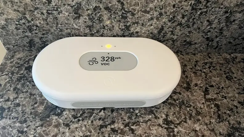 The View of Airthings View Plus on top of a marble counter with the air quality on screen.