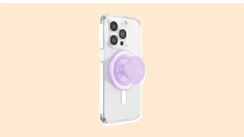 A PopSocket on the back of a smartphone on a vanilla-colored background.
