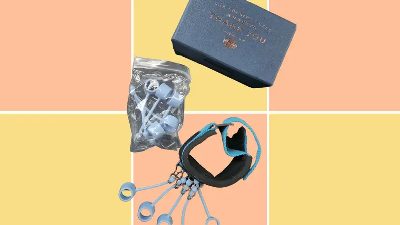 Strengthener, extra finger cots, and storage box against peach and yellow background