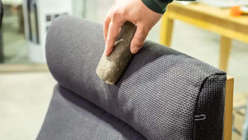 A person cleans a chair with the Fur-Zoff stone