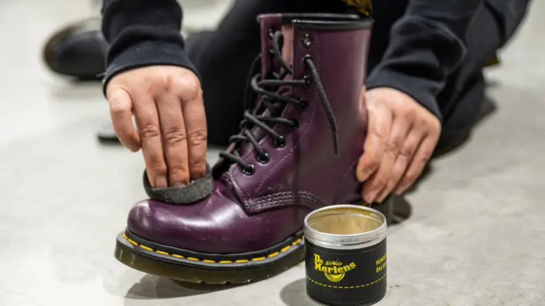 Rubbing leather softener on Doc Martens.