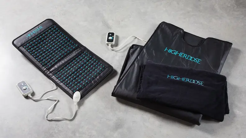 The Higher Dose Infrared Sauna Blanket and the Infrared PEMF Go Mat side-by-side on a floor.