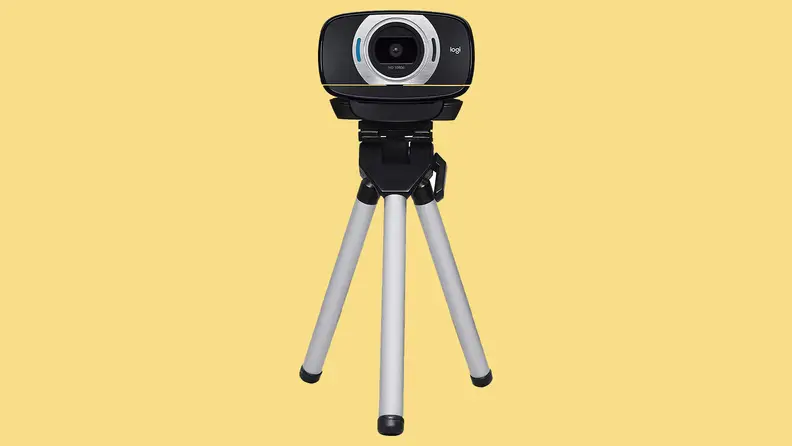 Webcam on tripod with yellow background