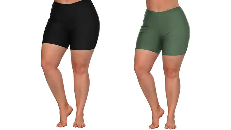 Two images of the same pair of high waisted swim board shorts, one in black and the other in a heathery green.