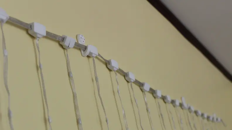 Close-up of the Govee Curtain lights being hung up by wall hooks.