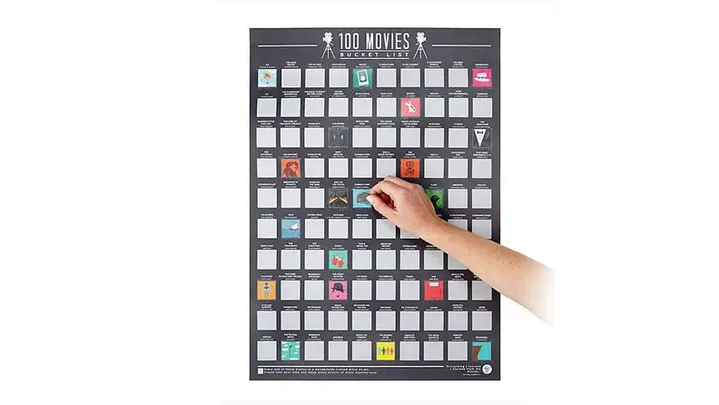 A person scratches off a square of a 100-movie scratch-off poster