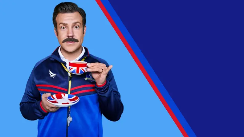 The character Ted Lasso holding a Union Jack teacup against a light blue background split in half with a red line with a dark blue background.