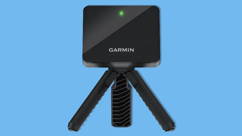 Garmin Approach R10 portable golf launch monitor on a blue background.