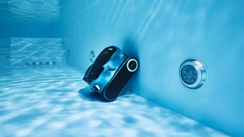Piper Scuba X1 Pro Max cleaning the walls and floor of a pool, shot from underwater