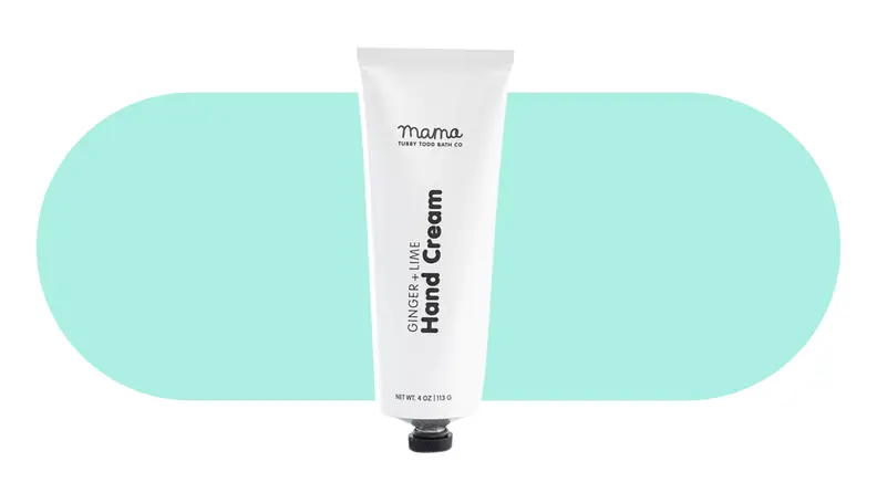 A tube of Tubby Todd Mama Hand Cream on a colorful background