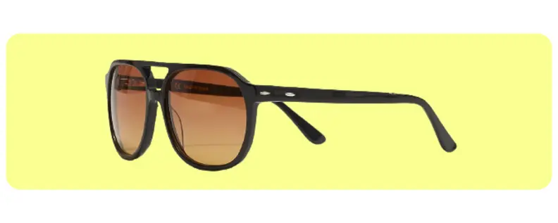 An oversized pair of aviator sunglasses against a yellow background.