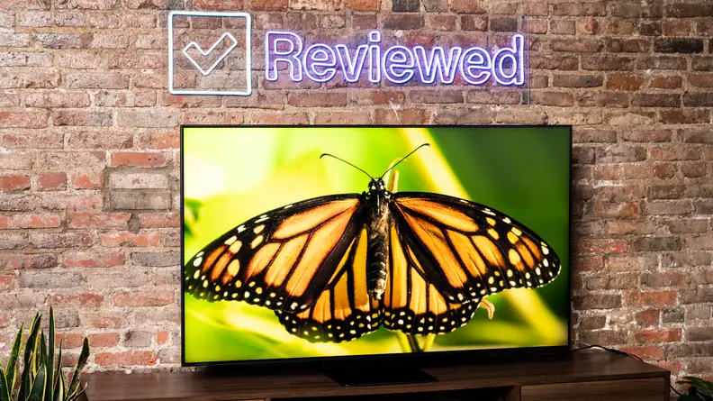 Smart television in front of brick wall.