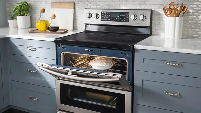 The  Samsung NE59J7850WS electric range shown with it's top oven door open. There is a lemon meringue pie in the oven.