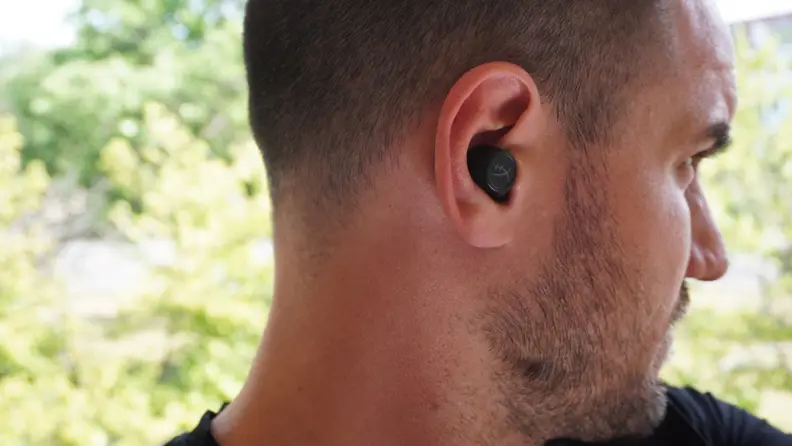 A man wearing the HyperX Cirro Buds Pro.