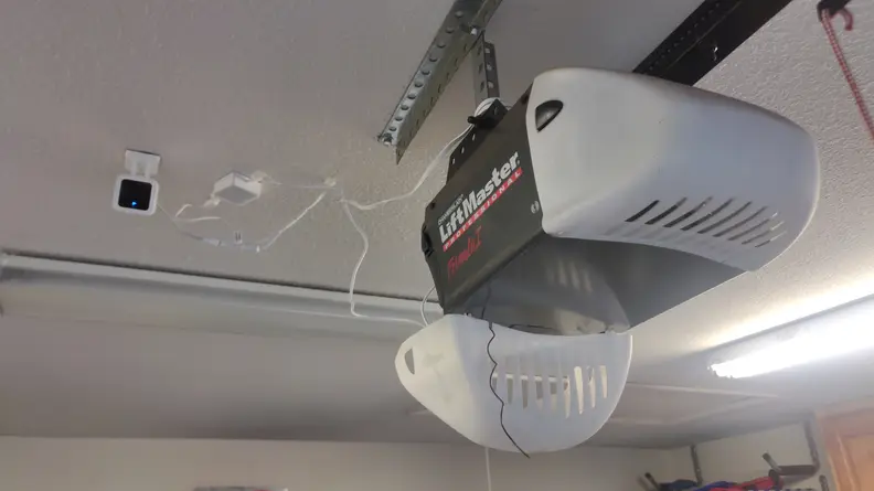 The Wyze camera set up next to the garage door operator.