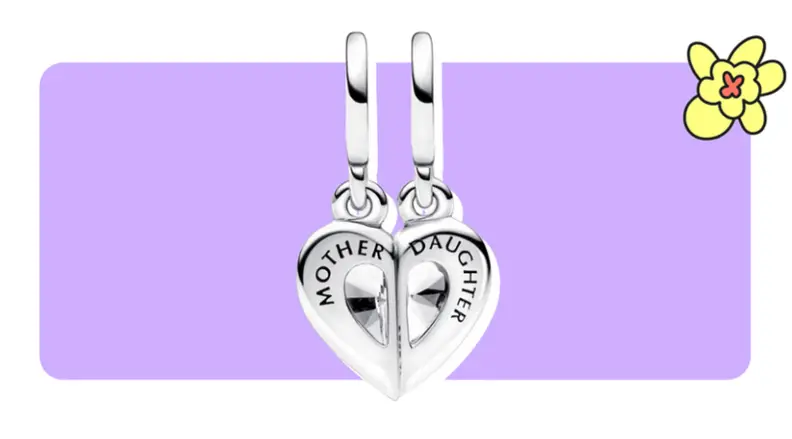 Two Pandora charms that have two halves on a single, silver heart in front of purple background with a yellow cartoon flower in the corner.