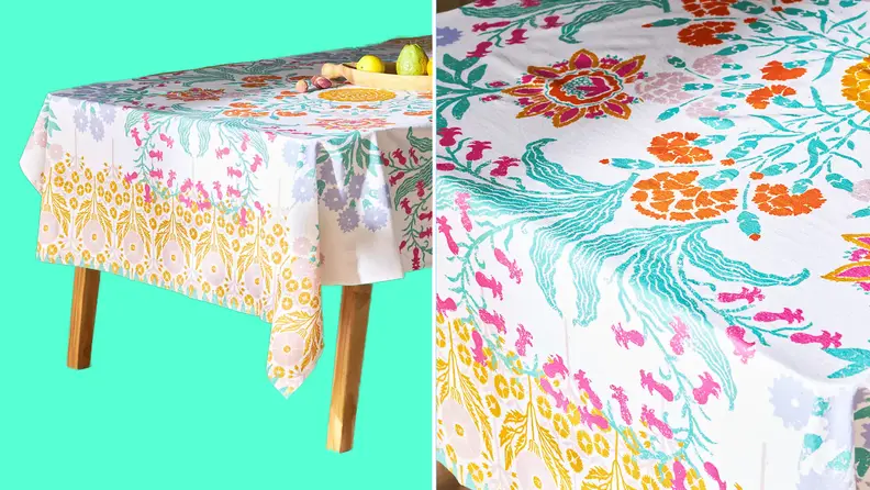 Product shot of multi-colored, printed tablecloth on top of table.