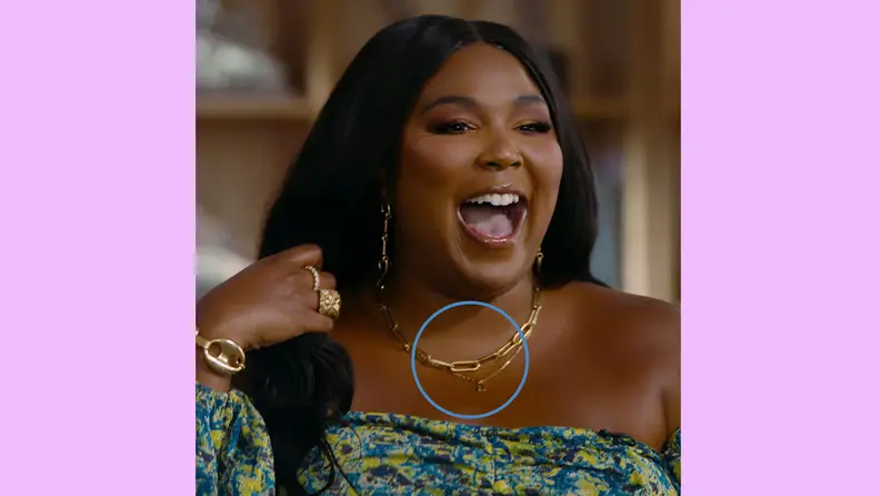 Lizzo smiling wearing jewelry