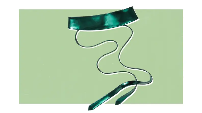 Product shot of a satin Obi belt with long tie strings.