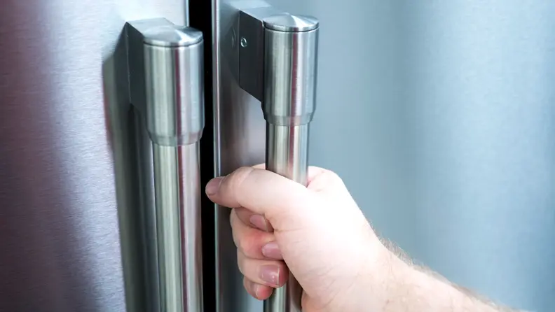 A contemporary looking refrigerator with rounded handles.