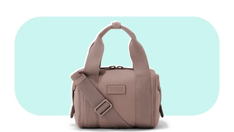 A rose-colored neoprene duffel bag with an extra strap.