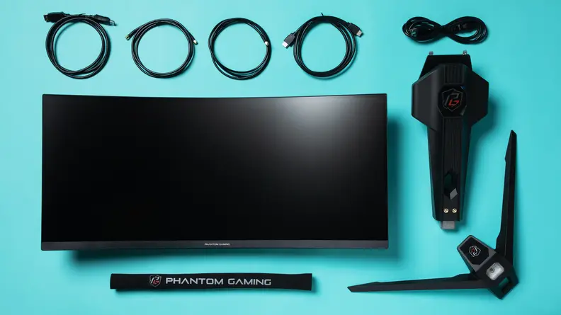 The cables and main parts of the ASRock Phantom Gaming PG34WQ15R2B monitor arrayed neatly on a sky blue surface.