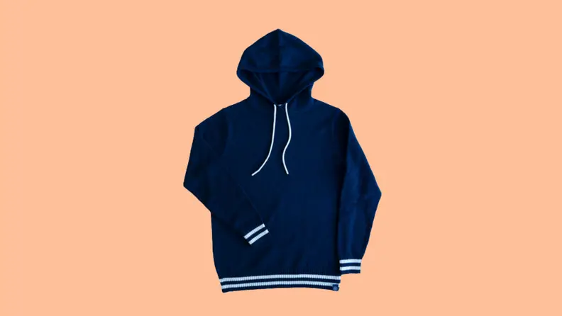A navy sweatshirt against an orange background.