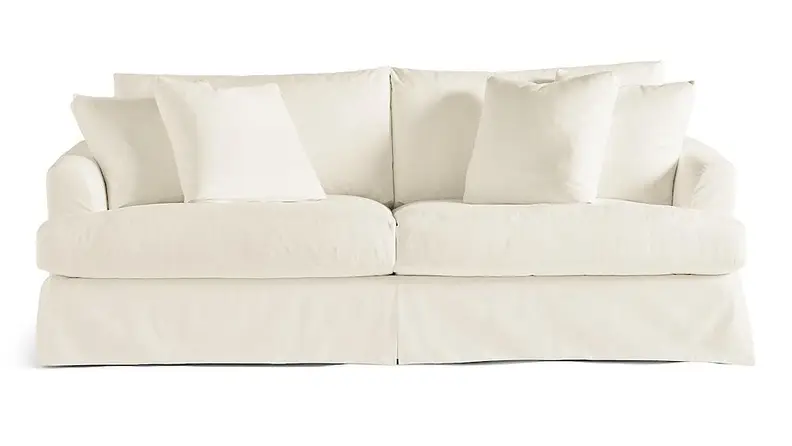 A cream couch on a white background.
