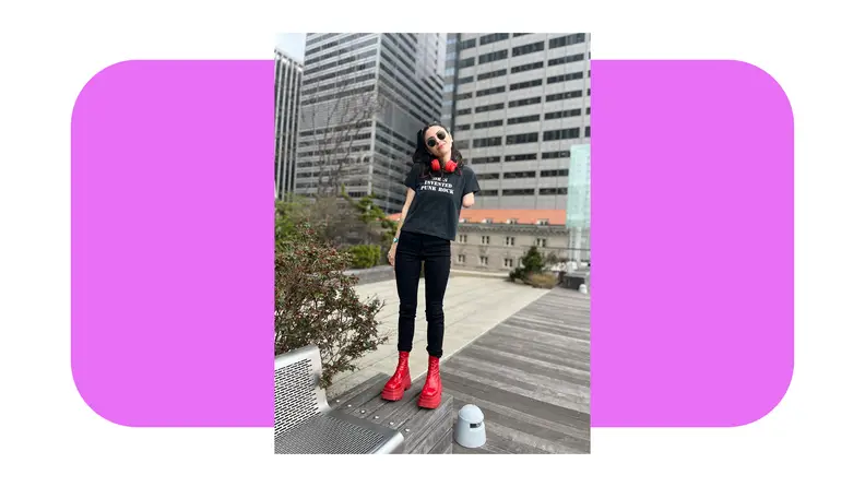 Person smiling outdoors while displaying the black Good American Always Fits Good Legs Skinny Jeans.