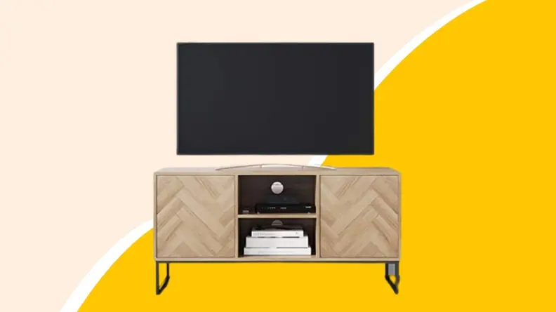 A wooden television console with television on top.