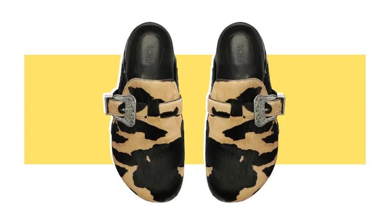 A pair of calf hair clogs that have a leopard print.