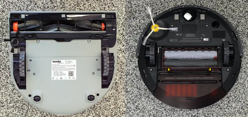 The Neato's D shape lets it clean closer to walls than the iRobot.
