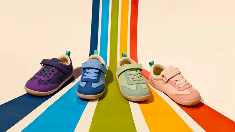 4 colors of retro suede sneakers on rainbow lines corresponding to the shoe color (purple, blue, green, pink)
